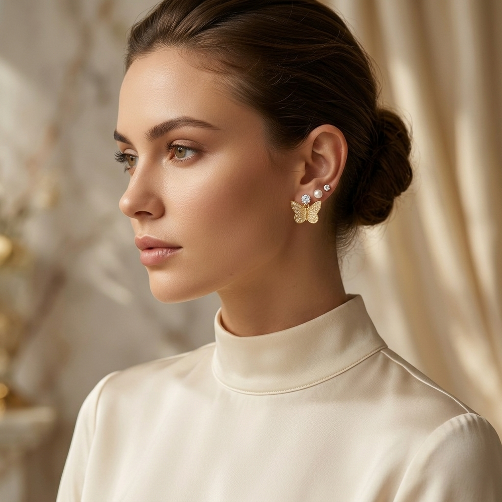 Woman wearing butterfly earrings with a neutral background