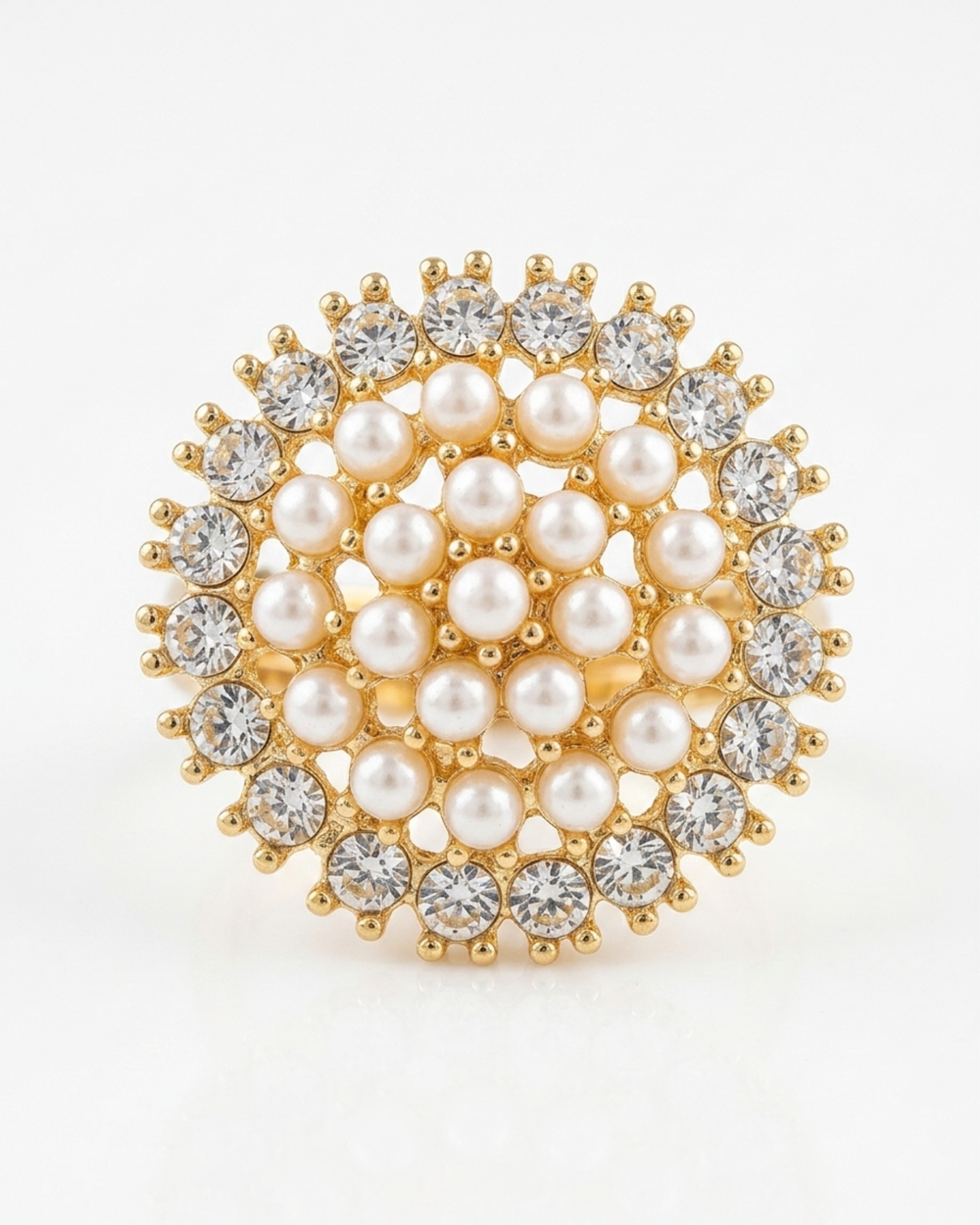 Gold brooch with pearls and crystals on a white background