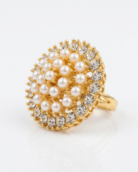 Gold ring with pearl and crystal embellishments on a white background