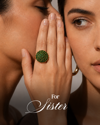 Close-up of a hand wearing a green gemstone ring with 'For Sister' text.