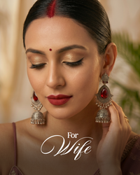 Woman wearing traditional earrings with a blurred background