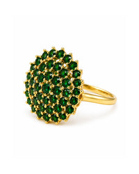 Gold ring with green gemstones on a white background