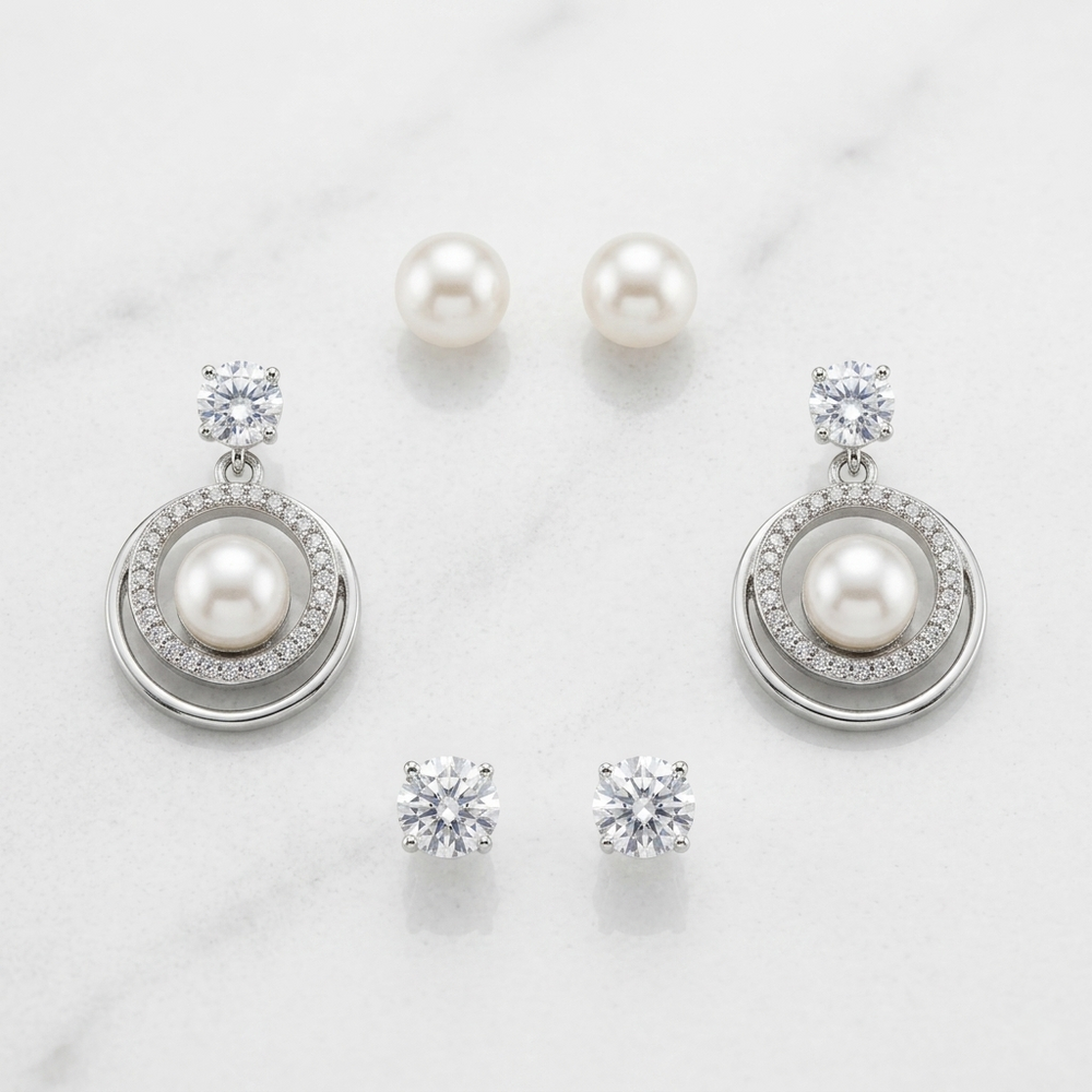 Pearl and crystal earrings on a light background