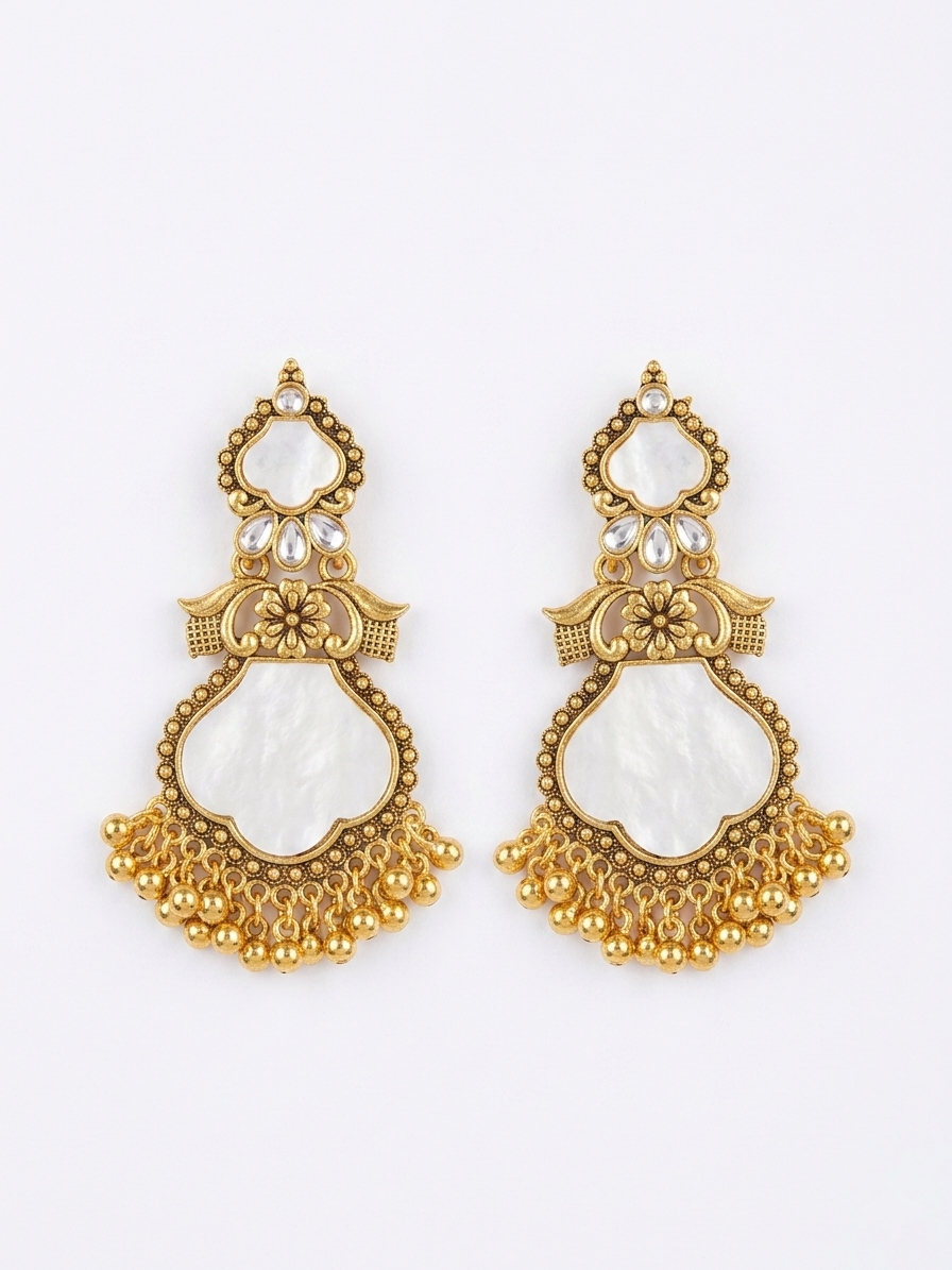 Pair of gold and white earrings on a white background