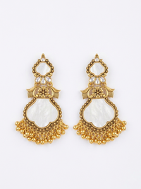 Pair of gold and white earrings on a white background