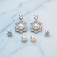 Pearl and crystal earring set on a marble surface
