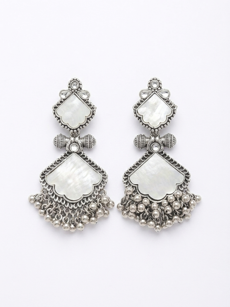 Pair of silver earrings with white stones on a white background
