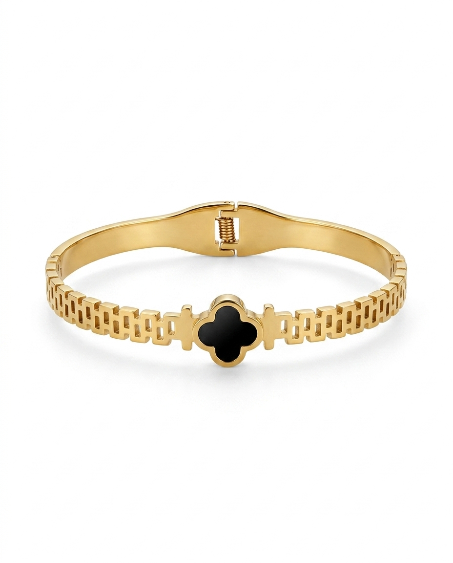Goldden bracelet with a black clover design on a white background