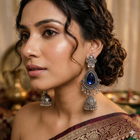 Woman wearing traditional earrings with a blurred background