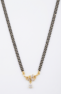 Black beaded necklace with a gold and crystal pendant on a white background