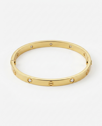 Gold bracelet with embedded stones on a white background