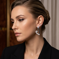 Close-up of a woman wearing heart-shaped earrings with a blurred background