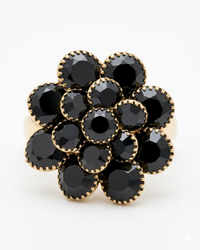 Gold ring with black gemstones on a white background