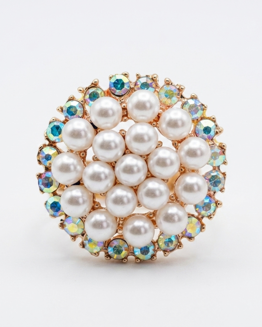 Ring with pearl-like stones and colorful gemstones on a white background