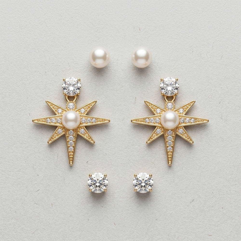 Gold star-shaped earrings with pearls and clear stones on a light gray background