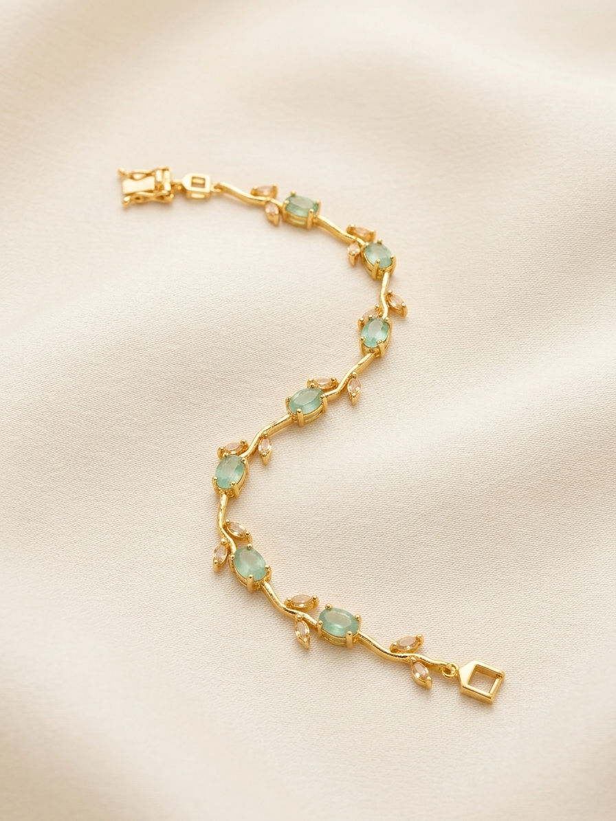 Gold bracelet with green gemstones on a beige background