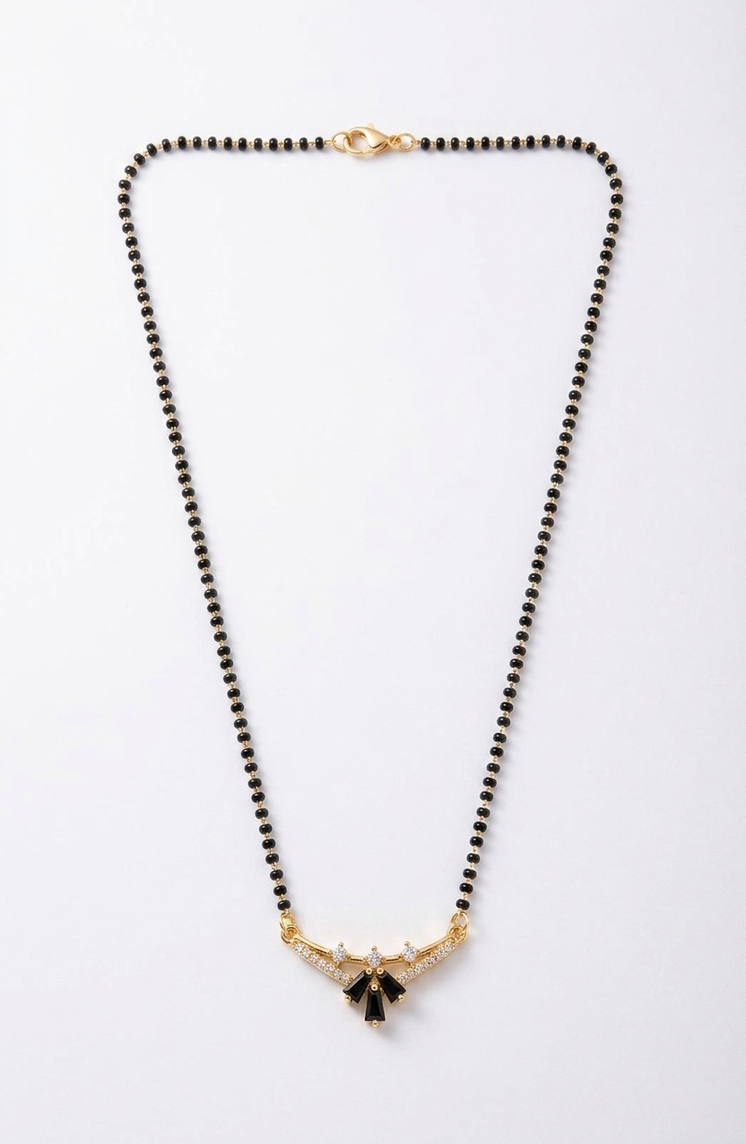 Necklace with black beads and gold accents on a white background