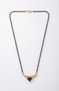 Necklace with black beads and gold accents on a white background